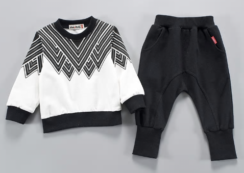 Two piece toddler boy sweatsuit. Long sleeve black and white designed top with black comfy pants with an elastic waist. 