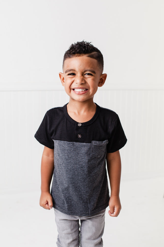 The Littlest Prince Black & Charcoal Block Henley Shirt is for the fashionable little gentleman who likes to take casual up a notch. This cool t-shirt is super comfy and can even be worn under a nice sports jacket with jeans. This set is perfect for stylish brothers as well as for matching daddy!