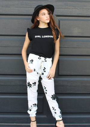 This two piece set is for the classy and sophisticated Boujie Babe. The fashion Girl London two piece set comes with the black flutter top and chiffon pants with drawstring tie. The pants have white shorts inside. The pants are chiffon so they are slightly see through giving it a perfect classic look. Your mini fashionista is ready for Rodeo Drive in this sleek outfit.