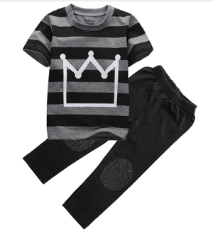 Toddler boy outfit comes with a grey and black striped t-shirt, a white crown symbol on the front and black pants with faux leather lining the knees. 