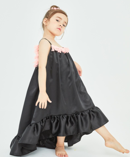 This gorgeous silk dress is just what the beautiful summer weather calls for. This slinky silk bodied dress comes higher in the front and longer in the back turning a fun dress into a fancy party outfit. The front and back are lined with hot pink tassels. Your mini diva will love to give this dress a twirl.
