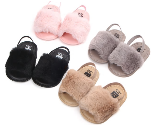 These adorable slippers come in 4 colors (beige, black, grey and pink) and have an elastic strap in the back to secure the slipper. The front of the slipper has a puff of faux fur to cover those little toes. We love this addition to our shoe collection!