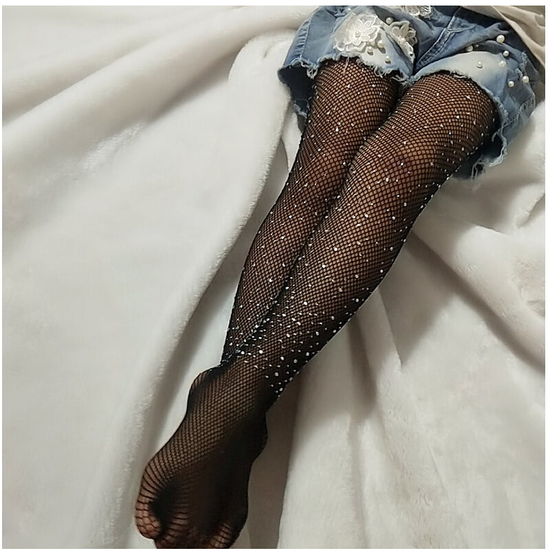 Add a little glitz and glam to your outfit with these adorable rhinestone tights. These fishnet style tights have different sized rhinestone's cascading up and down. Can fit child up to 5ft!  Available in black and brown! Boujie Kidz