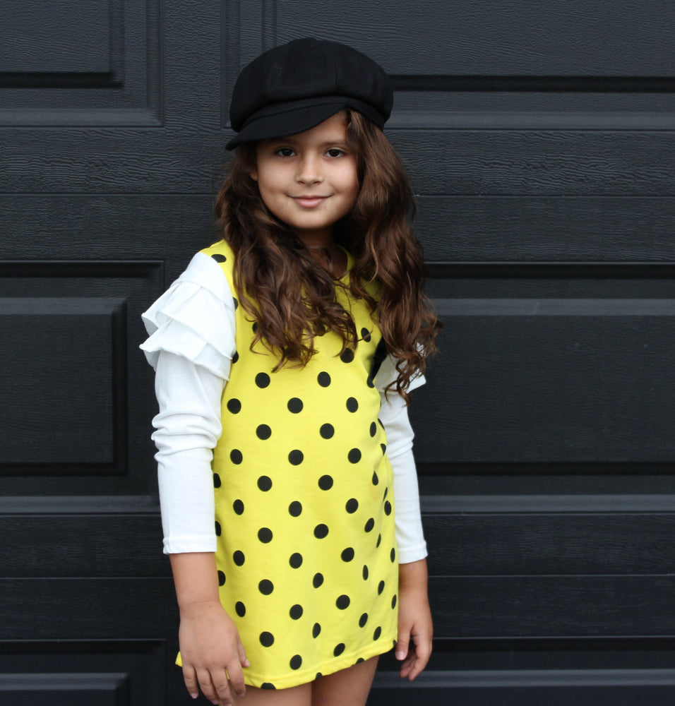 This fun polka dot dress is the perfect piece for a party! We have two vibrant colors in stock -Pink and Yellow. Both colors have long sleeves attached with ruffles on the shoulders. A bow sits on the left chest.