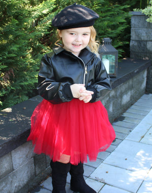 Leather tulle dress. Top part of dress is a leather jacket and the bottom has red tulle. The back of the dress is adorned with a huge diamond in sequins