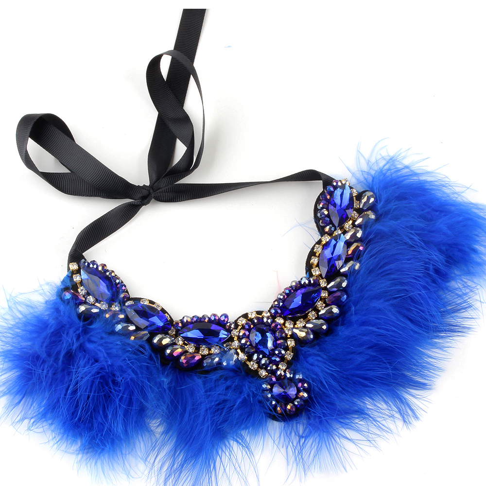 Calling all Boujie Diva's! Our crystal feather necklaces are the perfect addition for our mini diva's all the way up to our mama diva's. Each necklace sits high on top of your existing shirt and is lined with colorful feathers and shining crystals.  Mix and match with your mini for the perfect stylish accessory!  Available in beige, black, red and blue